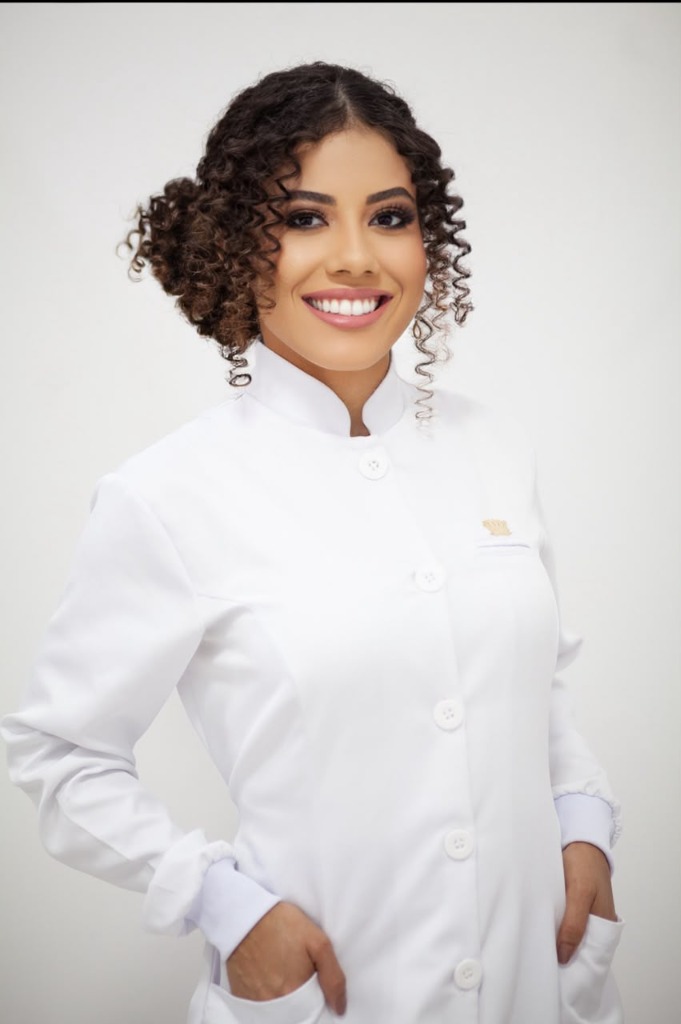 Valeria Rhibeiro de jaleco branco — Atendimento e avaliação individualizada em Estética Integrativa